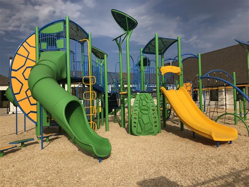 Medium playground slides at Aspen Academy in Savage, MN